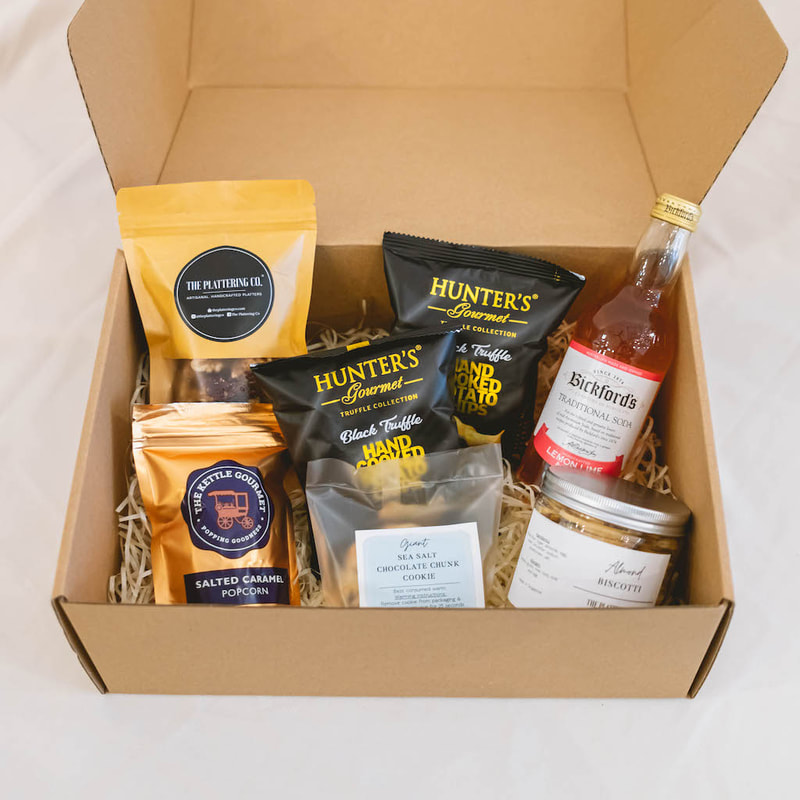 corporate snack box with nuts, the kttle gourmet popcorn, hunter's chips, bickford's soda and handmade chocolate chip cookie 